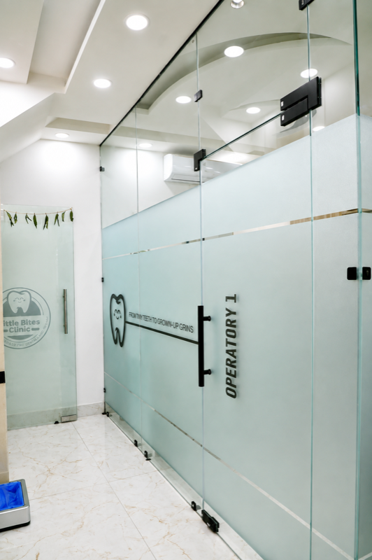 Glass operatory corridor with Little Bites Clinic branding